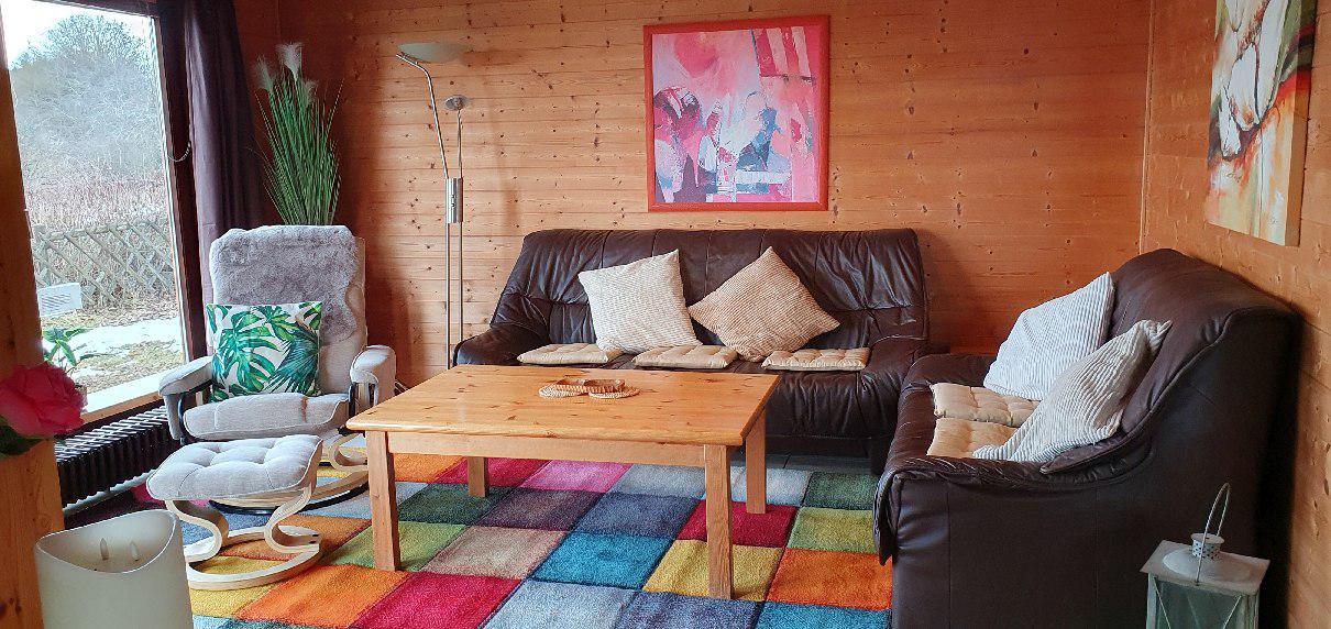 Wohnzimmer mit Sitzgruppe und buntem Teppich